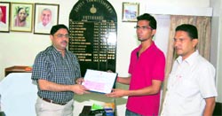 Fatehabad DC Vijay Singh Dahiya presents Dr Ambedkar Foundation award to Hitender.