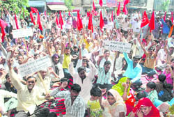 Power loom workers protest outside the Labour Commissioners office in Ludhiana on Monday.