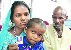 Parvati Devi, wife of martyr Santosh Kumar, shows his photograph