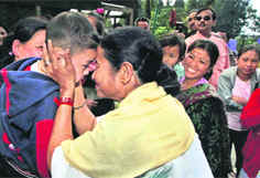 Railway Minister Mamata Banerjee greets a child during her visit to Darjeeling on Monday.