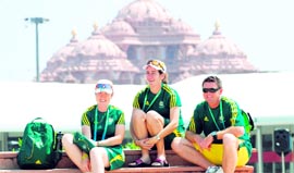 Members of the Australian contingent at the Games Village, seen with the Akshardham Temple in the background.