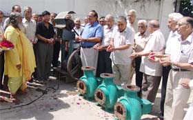 Members of the Shri Durgiana Management Committee perform puja before the start of installation process of water treatment plant at the Durgiana Temple in Amritsar