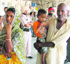Parvati with her son and father-in-law at the railway station in Ludhiana.