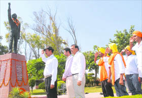 Abhey Singh Sandhu, nephew of Shaheed Bhagat Singh, and his son (in second row) pay homage to the martyr in Khatkar Kalan village on Tuesday. 
