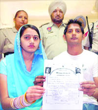 The newly wed couple shows proof of their marriage during a press conference at Rajpura on Tuesday.