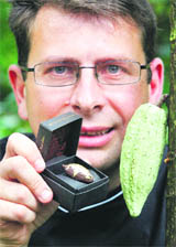 Chocolate maker Francois Stahl displays a chocolate called Selection Masoala, made only with Swiss ingredients, at Zurich zoo on Wednesday. The new chololate creation is made only with Swiss produced ingredients that includes cacao fruit coming from hte 11,000 square metres Zurich zoo artificial rainforest. The 150 hand-made chocolates will be put on sale for 155.44 euro. 