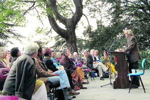 A poetry session goes on under a lyre tree during writers festival in Mussoorie.