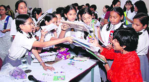 Roopa Pai, children writer, gives autographs to schoolchildren in Dehradun on Wednesday.