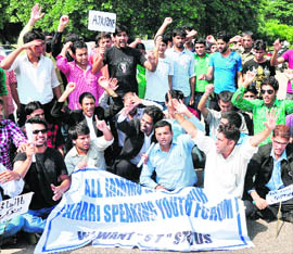 Activists of the All-Jammu and Kashmir Pahari-speaking Youth Forum hold a demonstration in support of their demands in Jammu on Wednesday.
