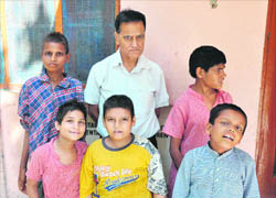  Project coordinator of the Childline, Jammu, along with mentally challenged children, who were handed over to the Home for Mentally Retarded Children at Channi Rama.