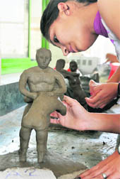 A student gives final touches to a clay model during a contest at PU youth festival in Ludhiana 