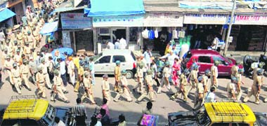 Policemen march as part of security measures a day ahead of the Allahabad HCs verdict on Ayodhya title suits, in Mumbai