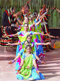 Schoolchildren perform at the flag hoisting event at the Games Village.