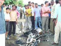 The bike which was set on fire outside an auto workshop in Kaithal.