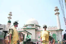 Securitymen keep vigil outside Raghunath Temple in Jammu on Thursday. 