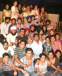 Jubilant students of the Apeejay College of Fine Arts and the HMV giddha team after winning trophies at the youth festival at GND University Regional Campus, Ladhewali, in Jalandhar on Thursday.