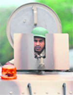 A policeman patrols on an armoured vehicle ahead of the Ayodhya verdict, in Mumbai 