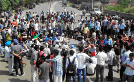 Staff and students of the Giani Zail Singh College of Engineering and Technology blocking the Bathinda-Dabwali road on Friday