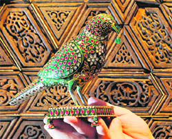 A jewel encrusted Indian parrot model on display at Christies auction rooms in Central London. The 18th century emerald ruby and diamond bird is estimated to fetch up to 600,000 when it is sold as part of the forthcoming Art of The Islamic and Indian Works auction on October 5.