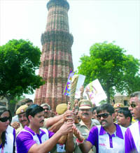Sportspersons and officials with the baton at the Qutub Minar.