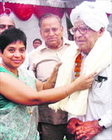 DC Neelam Pradip Kasni honours an elderly person in Karnal on Friday.