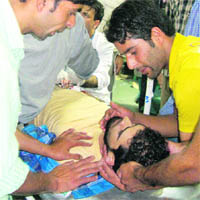 Zubair Ahmed Ganie, who was injured in a lathi charge by the police, being taken to hospital in Srinagar