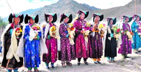 Buddhist women attired in traditional dresses on their way to a monastery on the outskirts of Leh.