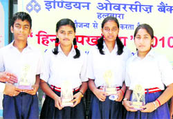 Students, who excelled in the Hindi fortnight celebrations, with their trophies 