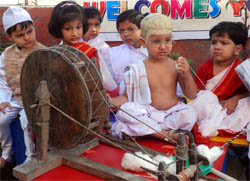 A tiny-tot of Daddys Teddy (left) dressed up as Mahatma Gandhi works on a spinning wheel (charkha) to mark the birth anniversaries of Mahatma Gandhi and Lal Bahadur Shastri in Bathinda on Saturday