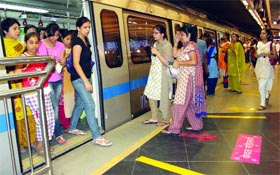 Women commuters board the special coach at Patel Chowk Metro station in New Delhi on Saturday.