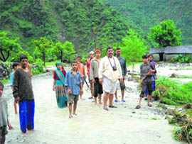 Farmers wait for rain water to recede at Pinrau village
