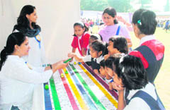 Students at a stall at the Fun-n-Fair fte at Carman School in Dehradun 