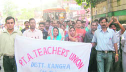 PTA teachers take out a protest rally in Kangra on Saturday.