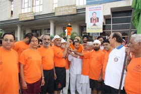 Mini-marathon participants hold a torch in Phagwara