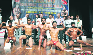 Contestants flex their muscles during the Mr J&K 2010 Competition at General Zorawar Singh Auditorium in Jammu on Saturday.