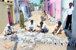 Work on the pavement of a street in progress in Naroor village, near Phagwara