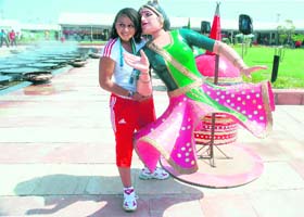 A foreign athlete having a gala time at the Games Village