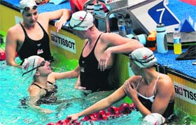 England swimmers share a light moment during a training session at the SP Mukherjee Aquatics Centre pool in New Delhi