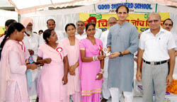 The staff of the Good Shepherd School honours Sandeep Jakhar on Sunday. 