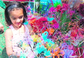 A girl looks at decoration items at a roadside stall in Dehradun