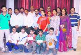 Badminton players who were presented with cheques at a function in Dehradun