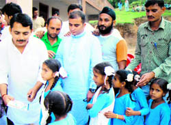 RS Pathania, senior vice-president, J&K Pradesh Youth Congress, distributes stationery among the needy children at the remote Chor Panjiam village on Sunday