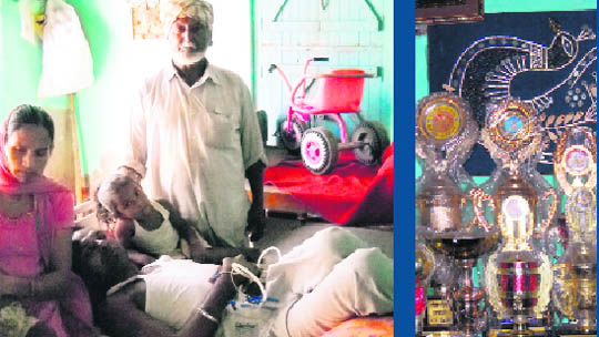 Keepa lies on the bed flanked by his family members; and mementoes won by him.