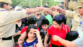 Cops form a human chain to control the crowd