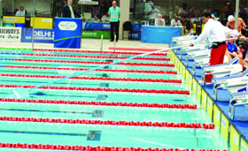 A volunteer cleans a pool at the S.P. Mukherjee Aquatics Centre in New Delhi on Monday