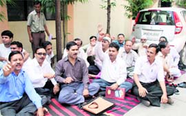 Pharmacists hold a protest at the Doon Hospital in Dehradun on Monday.
