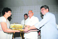 Chief Minister Bhupinder Singh Hooda presents a memento to film director Ajit Rai at DAV Girls College in Yamunanagar on Monday