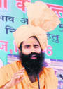 Swami Ramdev addresses a kisan sammelan at Kharkhoda in Sonepat district on Monday.