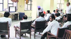 Lawyers watch TV in the Bar room as they struck work in protest against the registration of a case against their colleague in Ludhiana