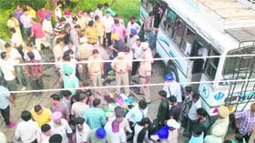 Police personnel and social activists render help at the scene of the bus accident near Phagwara